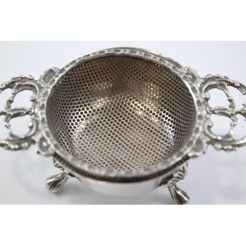 2257 - A Mappin & Webb hallmarked Birmingham sterling silver tea strainer and stand, dated 1971 - approx. g... 