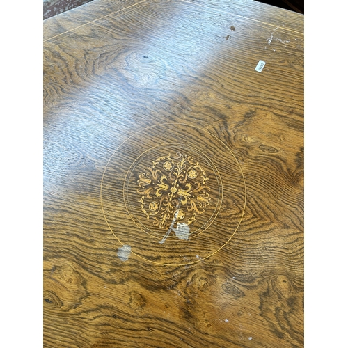 102 - A late Victorian inlaid rosewood octagonal two tier centre table on castors