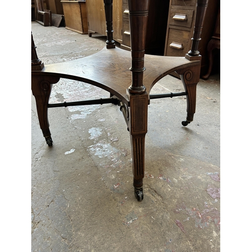 102 - A late Victorian inlaid rosewood octagonal two tier centre table on castors