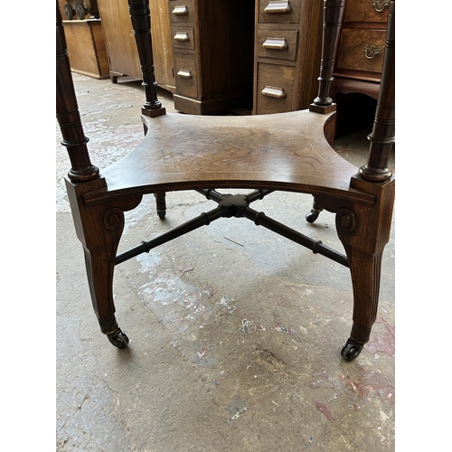 102 - A late Victorian inlaid rosewood octagonal two tier centre table on castors