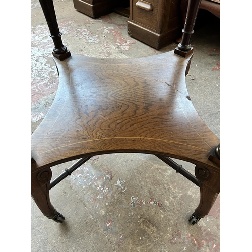 102 - A late Victorian inlaid rosewood octagonal two tier centre table on castors