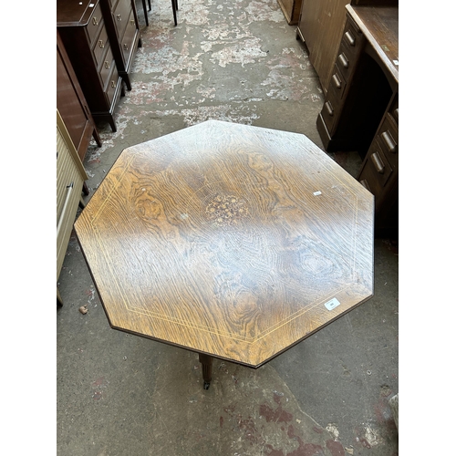 102 - A late Victorian inlaid rosewood octagonal two tier centre table on castors