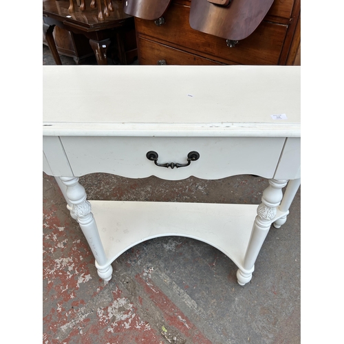 113 - A French style white painted two tier console table - approx. 88cm high x 122cm wide x 40cm deep