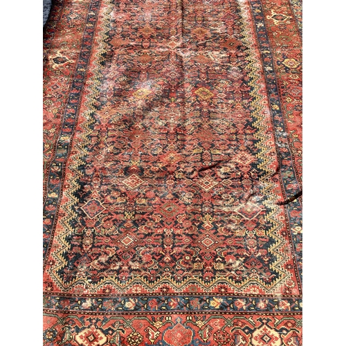 120 - An antique Persian hand knotted rug - approx. 300cm x 156cm