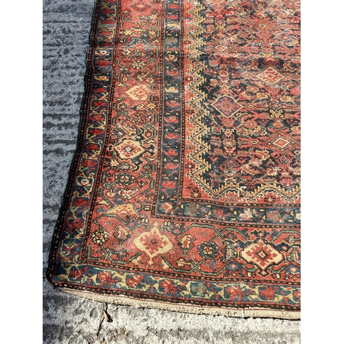 120 - An antique Persian hand knotted rug - approx. 300cm x 156cm