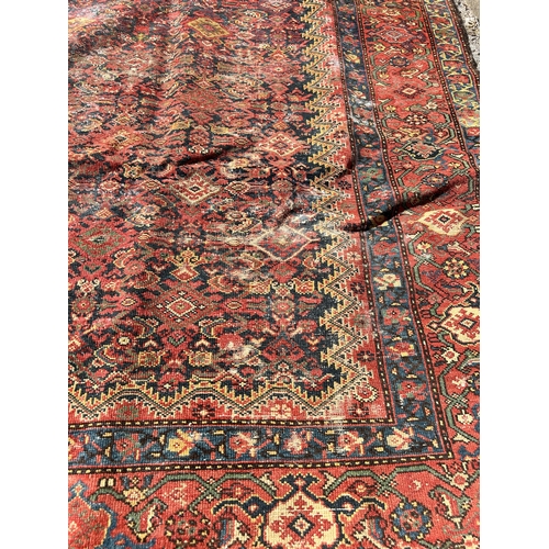 120 - An antique Persian hand knotted rug - approx. 300cm x 156cm