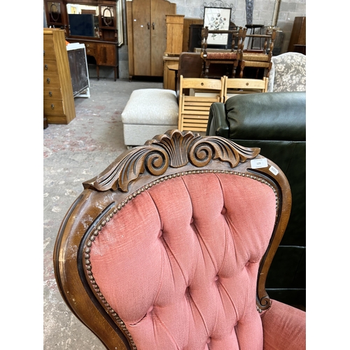 125 - A Victorian style carved beech and pink fabric upholstered spoon back armchair