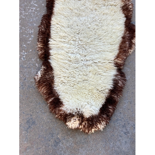 128 - A sheepskin rug - approx. 183cm x 62cm