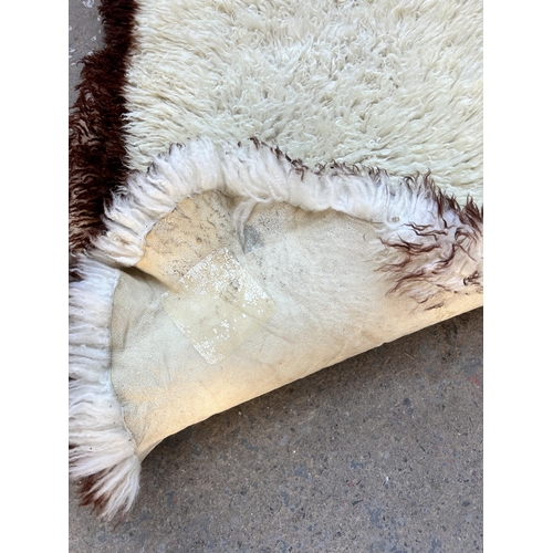 128 - A sheepskin rug - approx. 183cm x 62cm