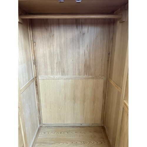 143 - A modern oak double wardrobe - approx. 192cm high x 100cm wide x 60cm deep