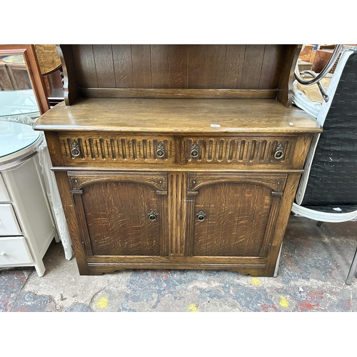 164 - A mid 20th century carved oak dresser