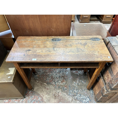 23 - A mid 20th century Kingfisher Ltd West Bromwich oak school desk on castors - approx. 79cm high x 102... 