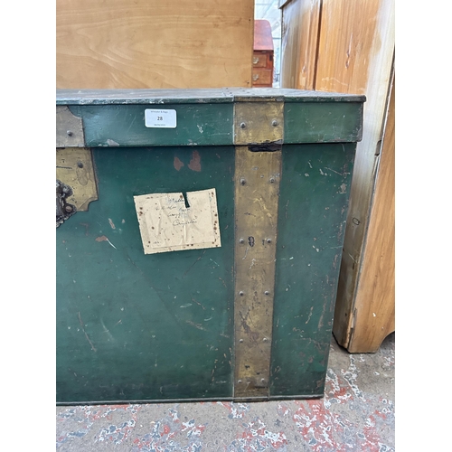 28 - An early 20th century green metal and brass banded travel trunk - approx. 52cm high x 84cm wide x 59... 