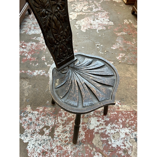 33 - An early 20th century carved oak spinning chair