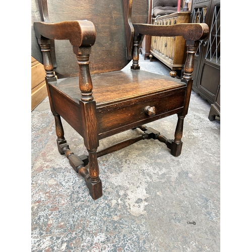 48 - A 17th century style oak monk's seat - approx. 127cm high x 88cm wide x 47cm deep