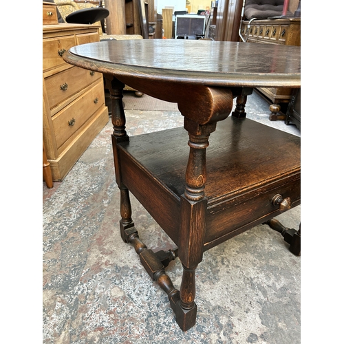 48 - A 17th century style oak monk's seat - approx. 127cm high x 88cm wide x 47cm deep