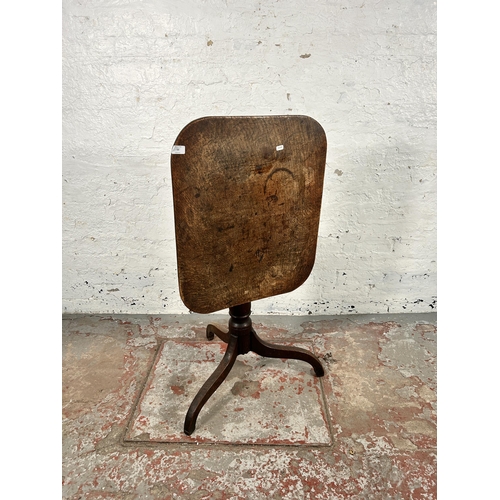 54 - A Georgian oak tilt top tripod occasional table - approx. 106cm high when tilted