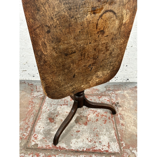 54 - A Georgian oak tilt top tripod occasional table - approx. 106cm high when tilted