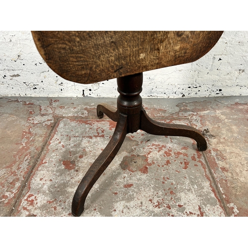 54 - A Georgian oak tilt top tripod occasional table - approx. 106cm high when tilted