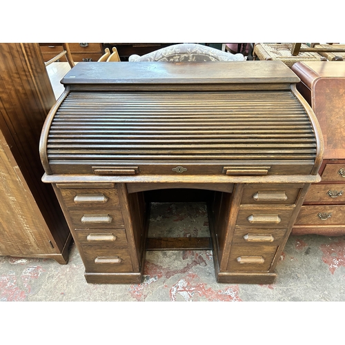 65 - An early 20th century Lebus oak roll top desk - approx. 102cm high x 106cm wide x 68cm deep