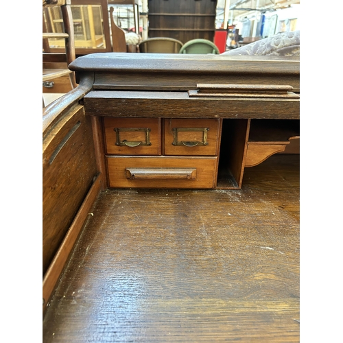 65 - An early 20th century Lebus oak roll top desk - approx. 102cm high x 106cm wide x 68cm deep