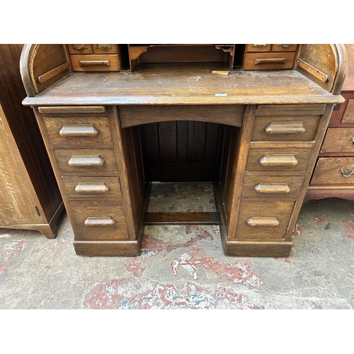 65 - An early 20th century Lebus oak roll top desk - approx. 102cm high x 106cm wide x 68cm deep