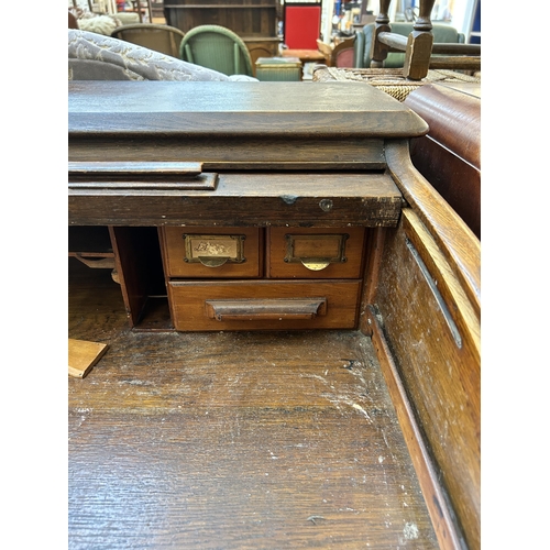 65 - An early 20th century Lebus oak roll top desk - approx. 102cm high x 106cm wide x 68cm deep