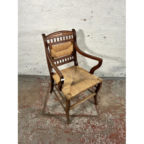 72 - A late 19th/early 20th century mahogany and rush woven armchair