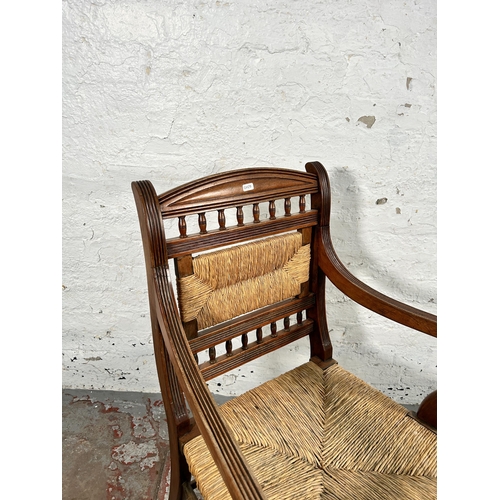 72 - A late 19th/early 20th century mahogany and rush woven armchair