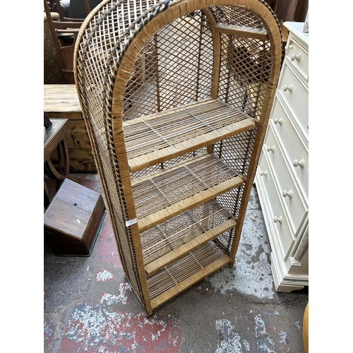 74 - A mid 20th century wicker four tier open arched bookcase - approx. 130cm high x 59cm wide x 28cm dee... 