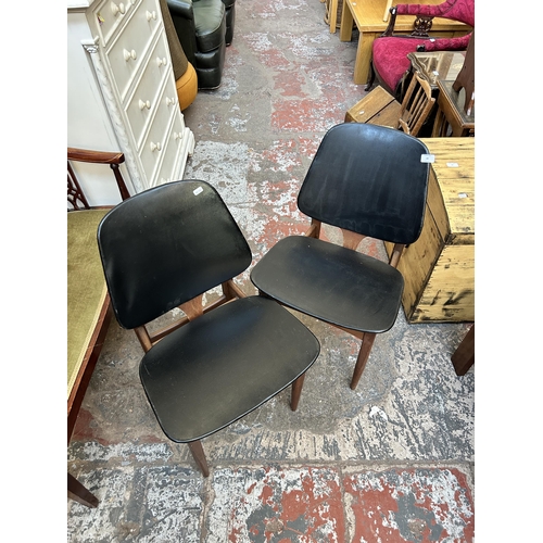 80 - A pair of 1960s Elliotts of Newbury teak and black vinyl dining chairs