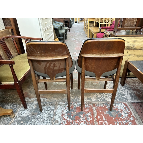 80 - A pair of 1960s Elliotts of Newbury teak and black vinyl dining chairs