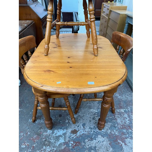 115 - A pine extending dining table and four chairs