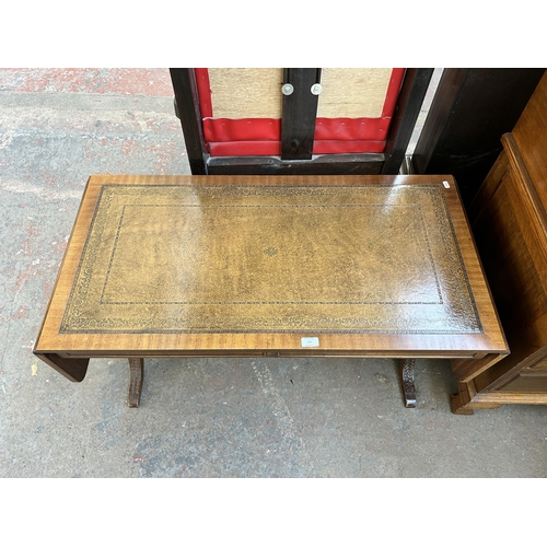 177 - A Regency style mahogany and brown leather drop leaf coffee table with lower stretcher