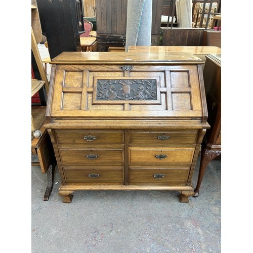 178 - An Edwardian Ralph Johnson Warrington carved oak bureau