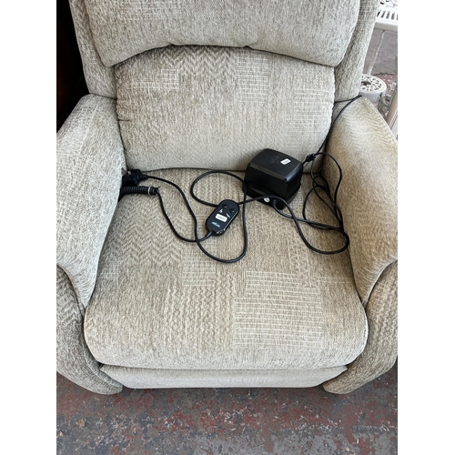 180 - A Restwell green fabric upholstered electric reclining armchair with remote and power supply