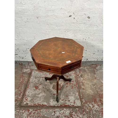 183 - A Regency style mahogany and brown leather drum table