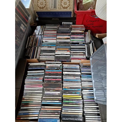 1018 - Eight boxes containing a large collection of vinyl records, CDs, cassette tapes and DVDs