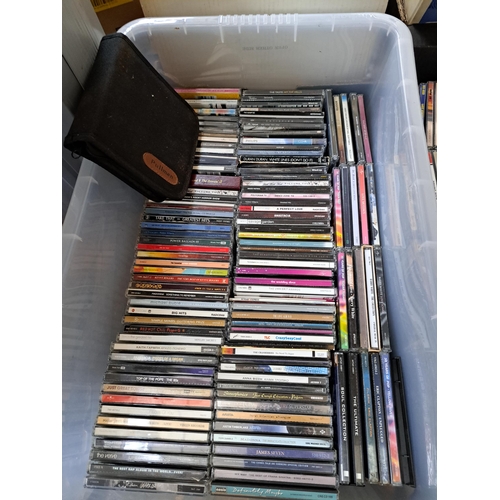 1018 - Eight boxes containing a large collection of vinyl records, CDs, cassette tapes and DVDs