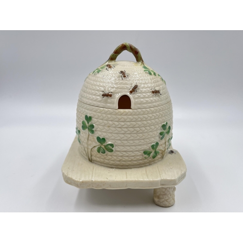 313 - A Belleek Shamrock honey pot on stand - approx. 15cm high