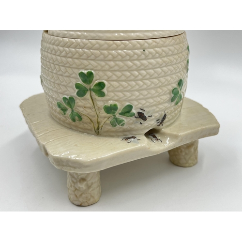 313 - A Belleek Shamrock honey pot on stand - approx. 15cm high