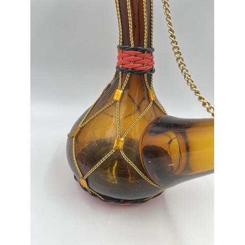 319 - A 1970s Spanish amber glass porron - approx. 30cm high