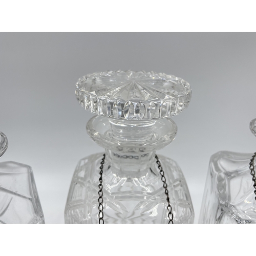 329 - Three crystal glass decanters with three Broadway & Co hallmarked Birmingham silver decanter labels,... 