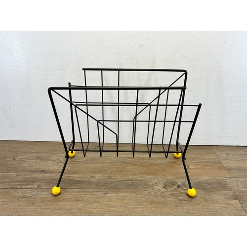 A mid 20th century Sputnik wrought metal magazine rack with yellow ...