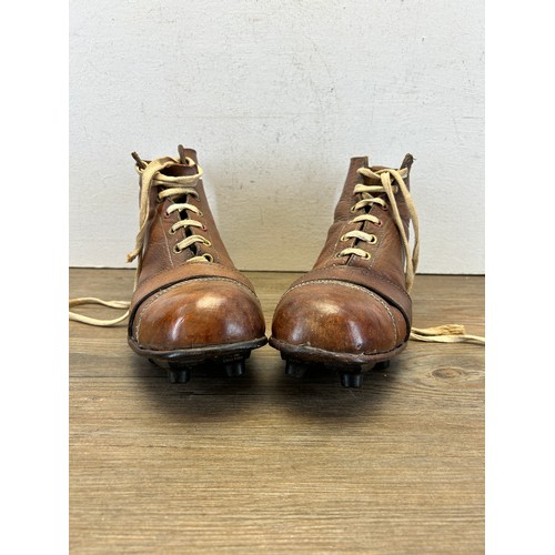 545 - A pair of 1940s brown leather football boots with fitted Rubstud studs