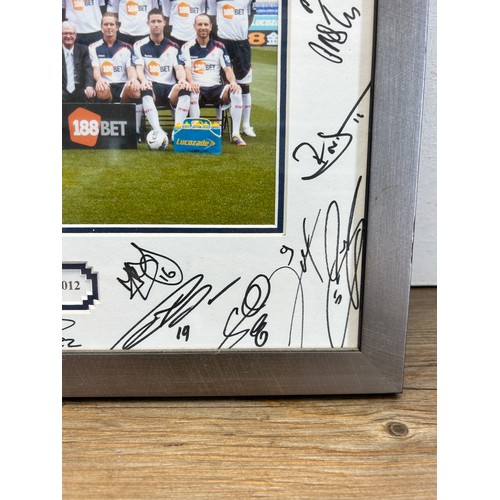 550 - A framed and signed Bolton Wanderers F.C. 2011-2012 photograph - approx. 32cm high x 42cm wide