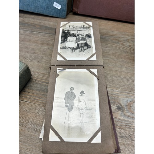 553 - A collection of antique and vintage photographs and postcards