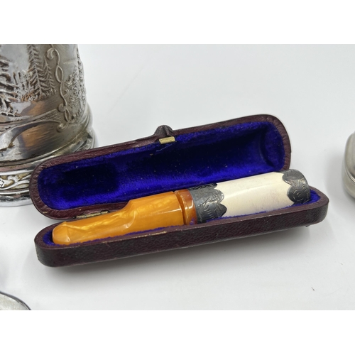 2330 - Five pieces of tobacciana to include Compact smoking pipe, leather cased clay cheroot holder with am... 