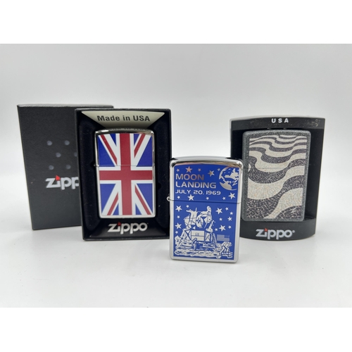 2332 - Three Zippo cigarette lighters to include Moon Landing etc.