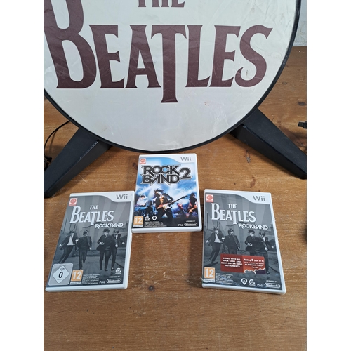 814 - A collection of Rock Band items to include limited edition Beatles Höfner bass and drum Wii controll... 